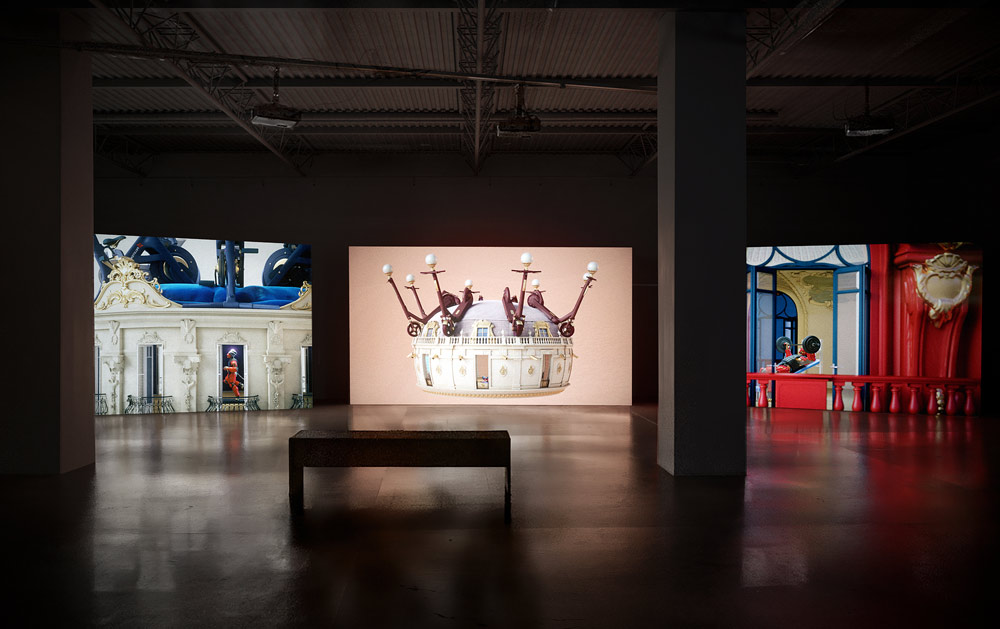 Video art installation showing three channels of projections in dark space